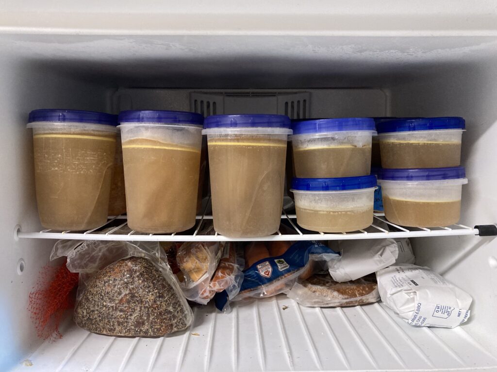 Top freezer shelf full of homemade chick stock. 