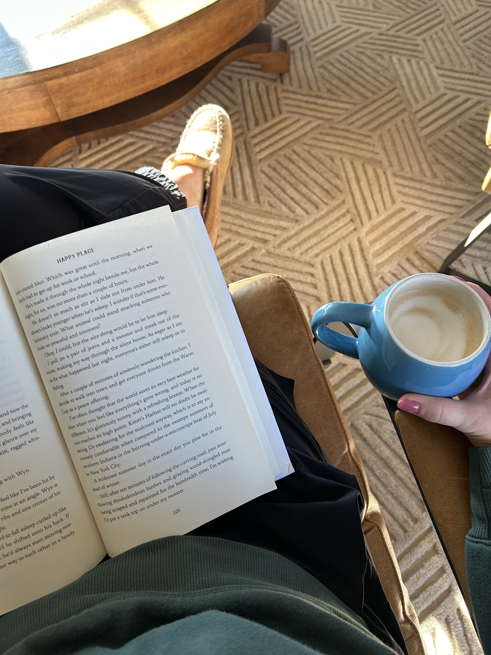Quiet morning moment with coffee, a book, and sunlight streaming through a window.